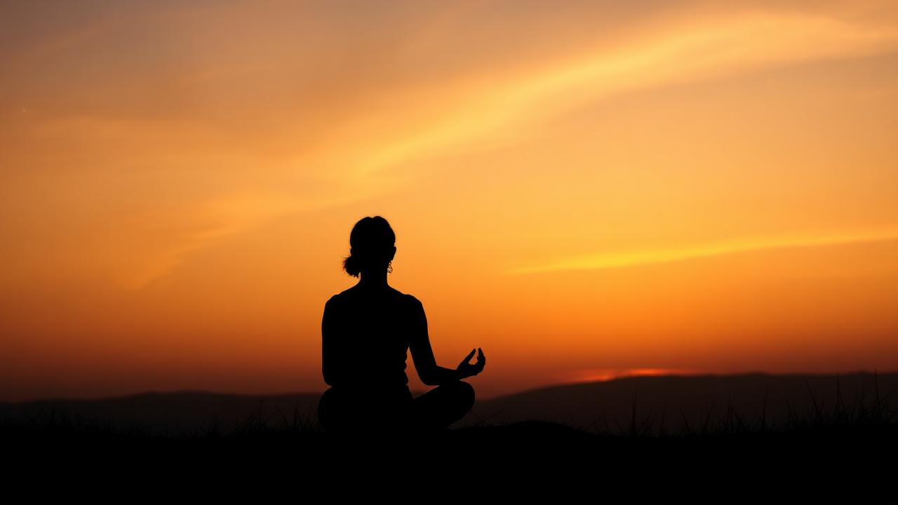 Person seated in quiet meditation at dawn